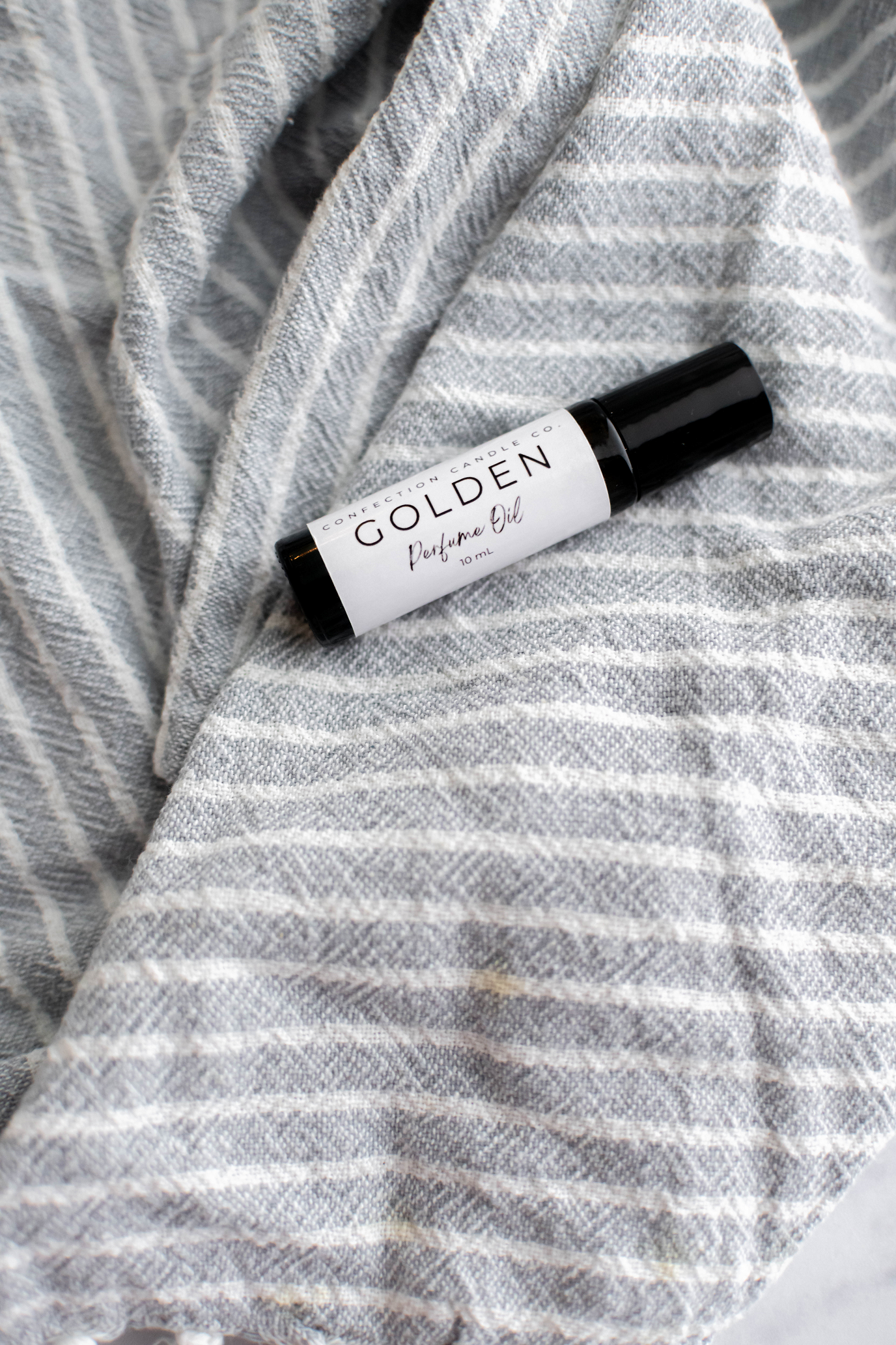 Amber glass roller bottle of perfume oil.