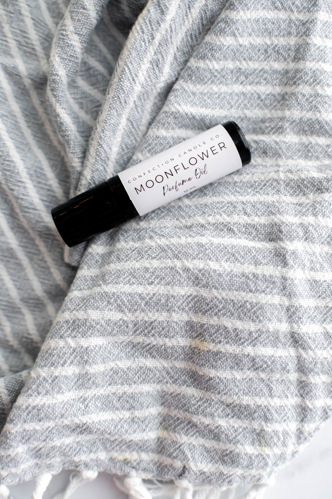 Amber glass roller bottle of perfume oil.