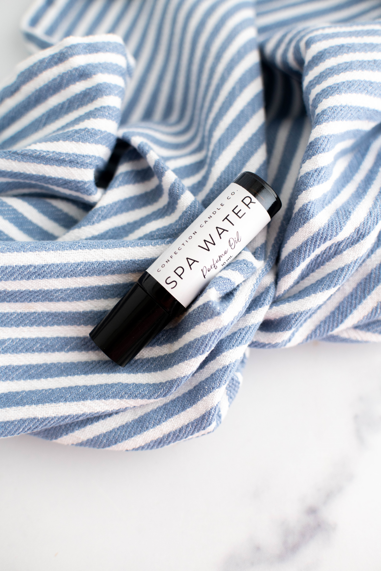 Amber glass roller bottle of perfume oil.