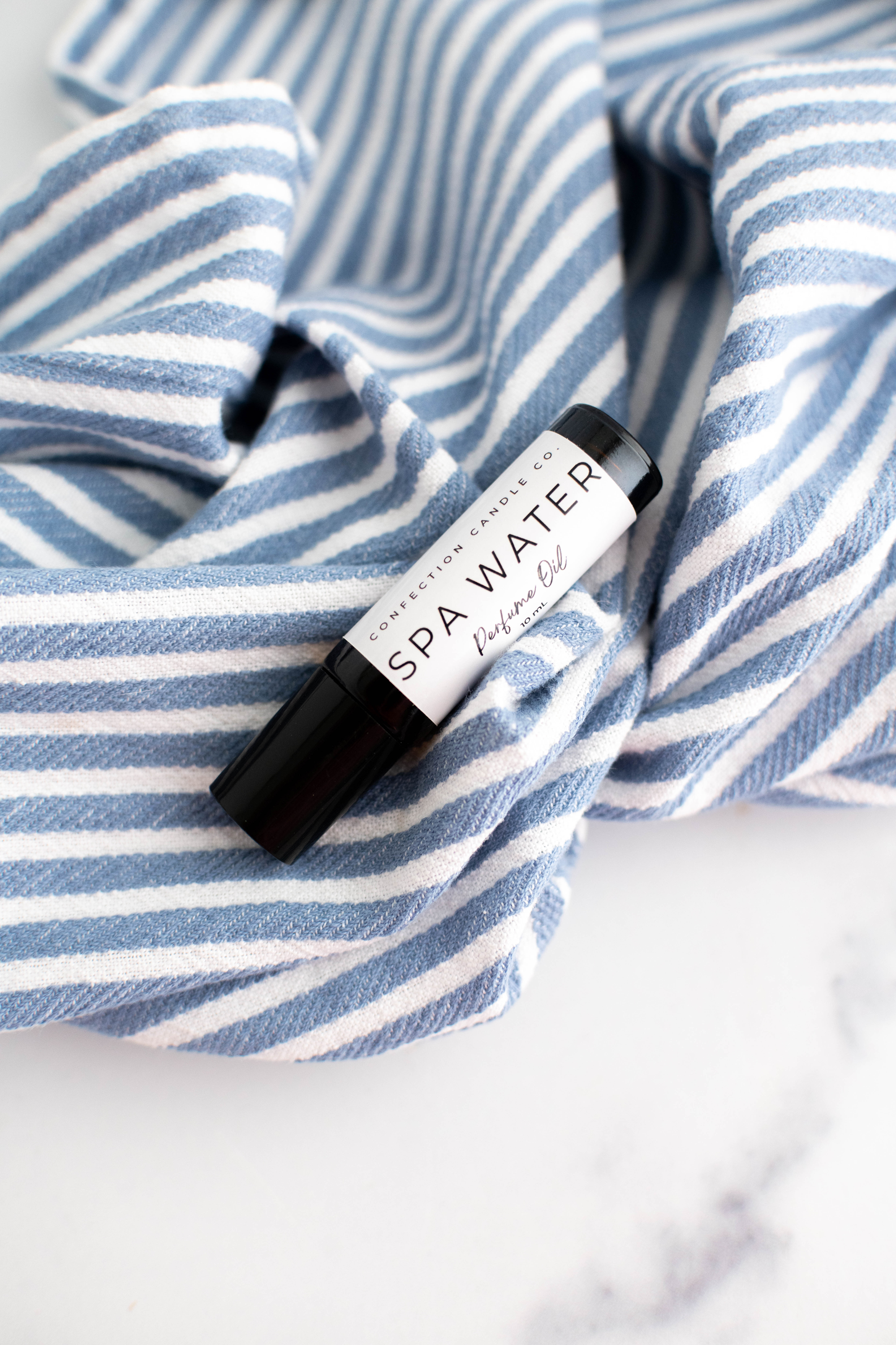 Amber glass roller bottle of perfume oil.