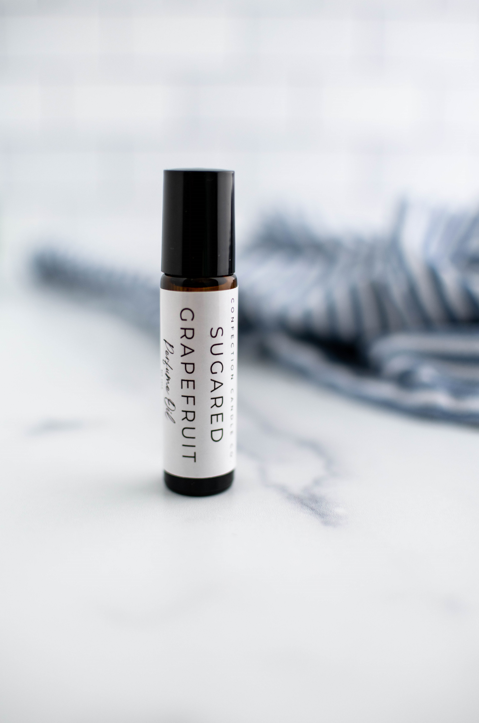 Amber glass roller bottle in the fragrance Sugared Grapefruit.