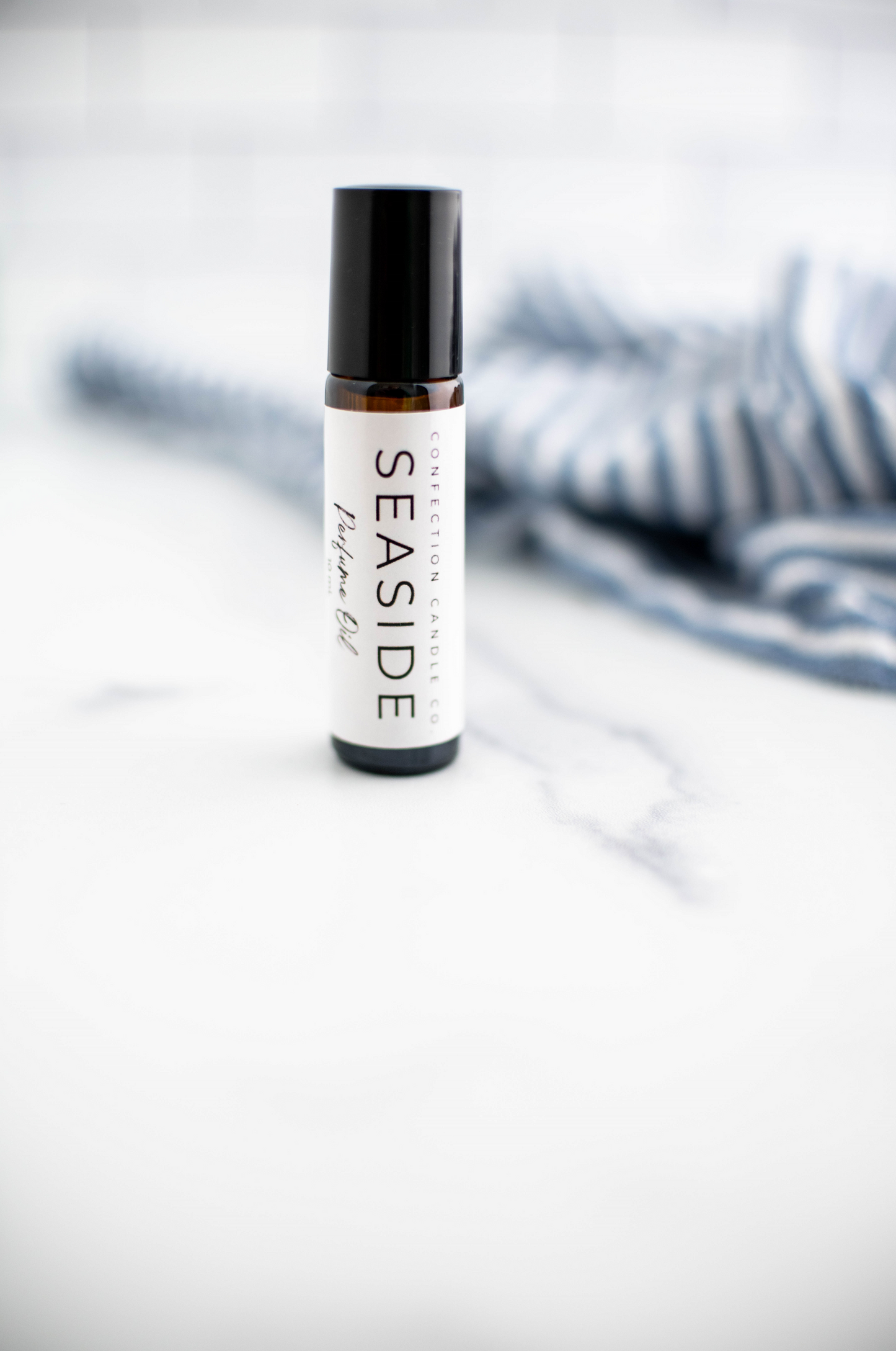 Amber glass roller bottle in the fragrance Seaside.